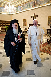 Pope Francis walks with Ecumenical Patriarch Bartholomew of Constantinople at Vatican