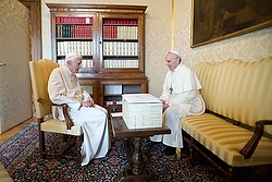 Emeritus Pope Benedict XVI talks with Pope Francis during their private meeting at papal summer residence in Castel Gandolfo